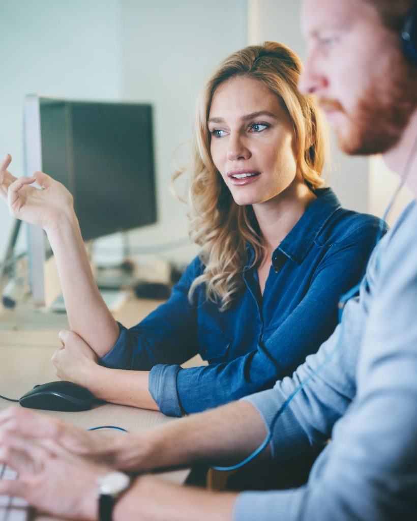 Programmers cooperating at information technology company